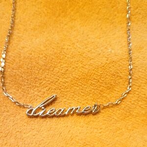 Gold tone dreamer necklace